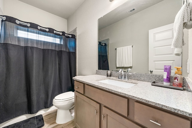 24743 Levante Dr, Richmond, TX 77406 - full bathroom featuring vanity, wood finished floors, toilet, and a shower with shower curtain