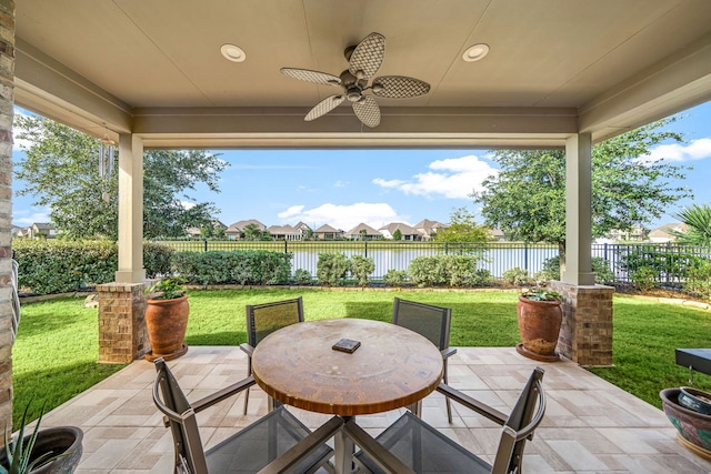 24743 Levante Dr, Richmond, TX 77406 - view of patio / terrace with a ceiling fan, outdoor dining space, a water view, and a residential view