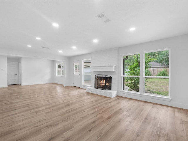 9414 Stockport Dr, Spring, TX 77379 - unfurnished living room featuring recessed lighting, a fireplace, light wood finished floors, and baseboards