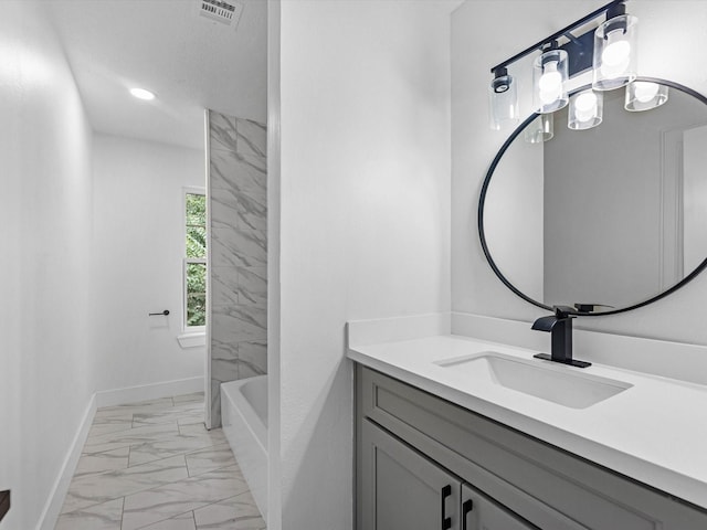 9414 Stockport Dr, Spring, TX 77379 - full bathroom with marble look tiles, vanity, and baseboards