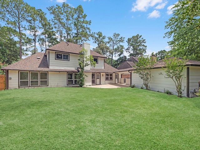 9414 Stockport Dr, Spring, TX 77379 - back of property featuring a patio area, roof with shingles, and a chimney