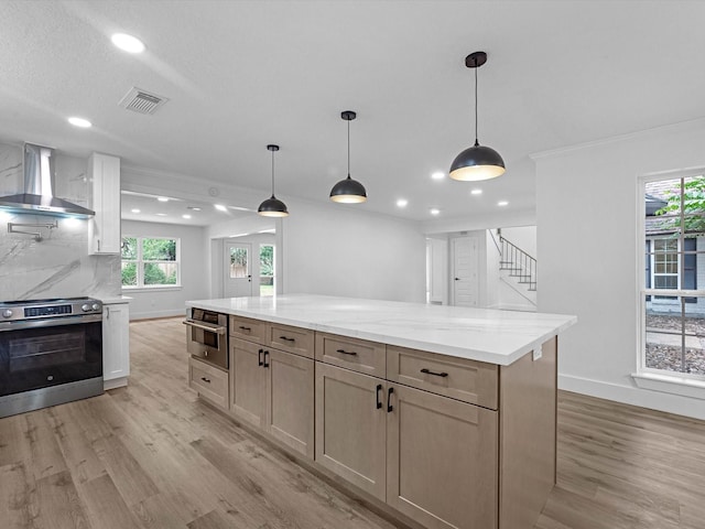 9414 Stockport Dr, Spring, TX 77379 - kitchen with wall chimney range hood, stainless steel appliances, light wood finished floors, recessed lighting, and baseboards
