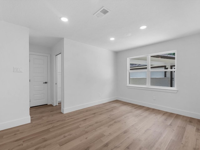 9414 Stockport Dr, Spring, TX 77379 - spare room featuring baseboards, light wood-style floors, and recessed lighting