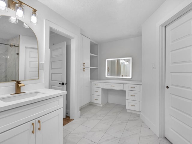 9414 Stockport Dr, Spring, TX 77379 - bathroom with marble look tiles, vanity, a marble finish shower, and a textured ceiling