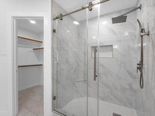9414 Stockport Dr, Spring, TX 77379 - full bathroom featuring a marble finish shower, a walk in closet, and marble finish floors