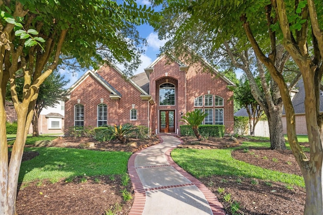 22719 Arbor Stream Dr, Katy, TX 77450 - traditional home with brick siding, french doors, and a front lawn