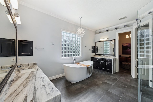 22719 Arbor Stream Dr, Katy, TX 77450 - full bathroom featuring a chandelier, two vanities, a soaking tub, crown molding, and baseboards