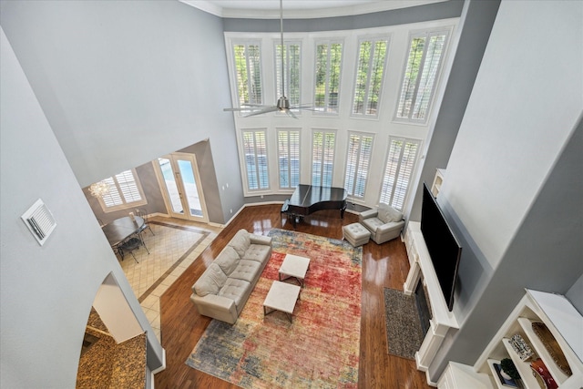 22719 Arbor Stream Dr, Katy, TX 77450 - living area featuring a towering ceiling, wood finished floors, baseboards, a ceiling fan, and french doors