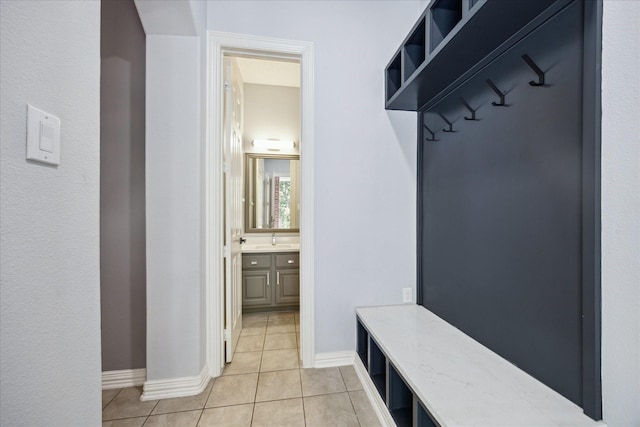22719 Arbor Stream Dr, Katy, TX 77450 - mudroom featuring light tile patterned flooring, baseboards, and a sink