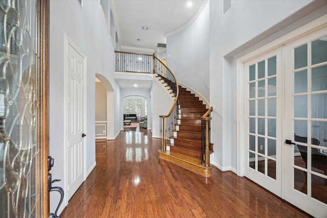 22719 Arbor Stream Dr, Katy, TX 77450 - foyer entrance featuring arched walkways, a high ceiling, wood finished floors, crown molding, and french doors
