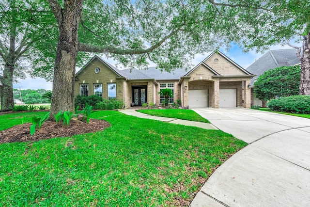 4322 Cannondale Ln, Katy, TX 77450 - view of front of house with french doors, an attached garage, driveway, brick siding, and a front lawn