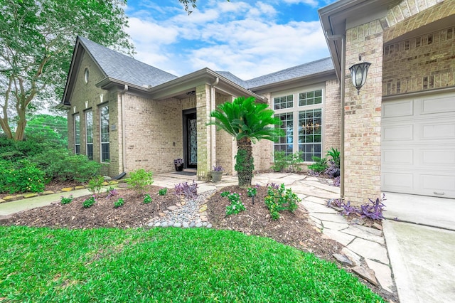 4322 Cannondale Ln, Katy, TX 77450 - view of exterior entry featuring brick siding, roof with shingles, and a garage