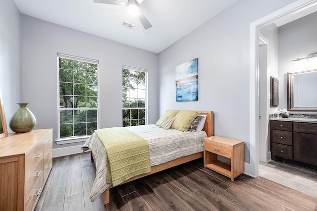 4322 Cannondale Ln, Katy, TX 77450 - bedroom with dark wood-style floors, ensuite bath, ceiling fan, and baseboards