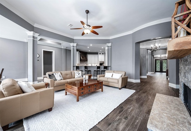 4322 Cannondale Ln, Katy, TX 77450 - living area featuring decorative columns, a ceiling fan, ornamental molding, dark wood-type flooring, and a chandelier
