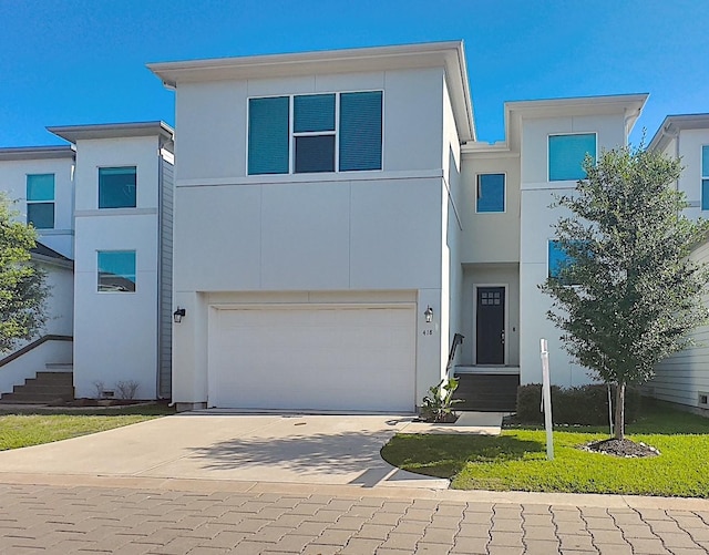 418 Yale Oaks Ln, Houston, TX 77091 - view of front of home featuring concrete driveway, stucco siding, and a garage