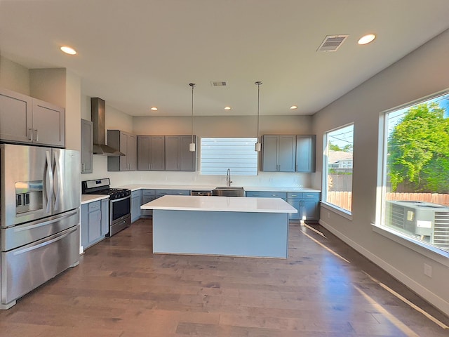 418 Yale Oaks Ln, Houston, TX 77091 - kitchen with appliances with stainless steel finishes, wall chimney exhaust hood, a sink, recessed lighting, and light countertops