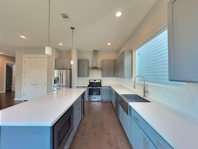 418 Yale Oaks Ln, Houston, TX 77091 - kitchen with appliances with stainless steel finishes, wall chimney range hood, recessed lighting, a sink, and tasteful backsplash