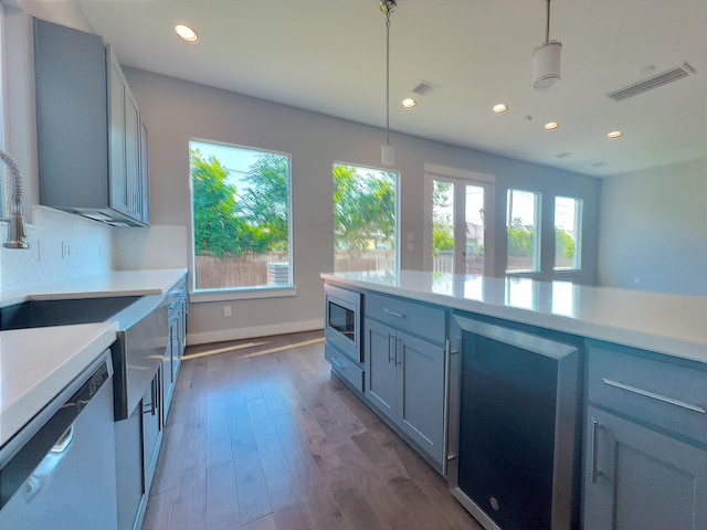 418 Yale Oaks Ln, Houston, TX 77091 - kitchen with stainless steel appliances, wine cooler, recessed lighting, light countertops, and a sink