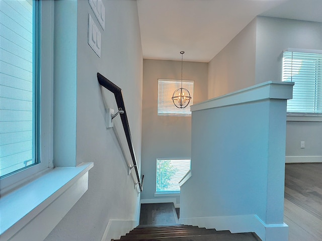418 Yale Oaks Ln, Houston, TX 77091 - stairway with a chandelier, baseboards, and wood finished floors