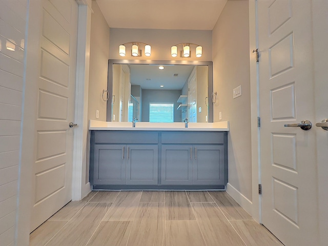 418 Yale Oaks Ln, Houston, TX 77091 - full bathroom featuring double vanity, baseboards, and wood finish floors