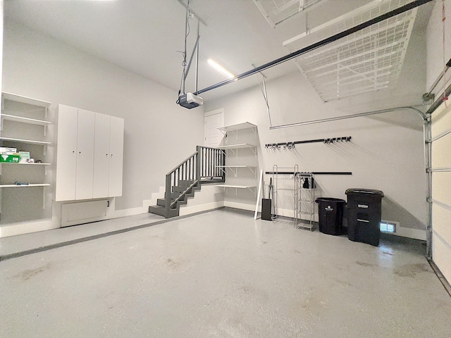 418 Yale Oaks Ln, Houston, TX 77091 - garage featuring baseboards and a garage door opener