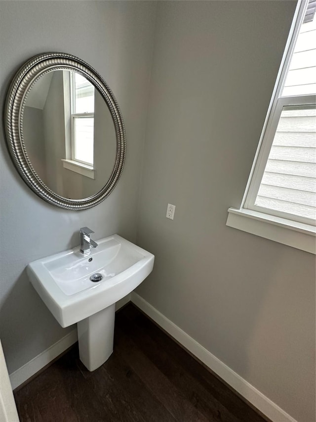418 Yale Oaks Ln, Houston, TX 77091 - bathroom with baseboards, wood finished floors, and a sink