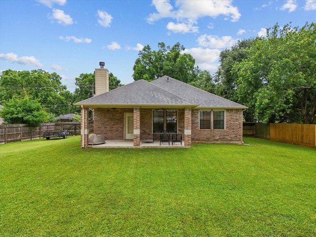 12008 7th St, Santa Fe, TX 77510 - back of house with a shingled roof, a patio, a chimney, and brick siding