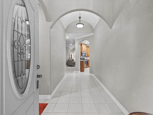12008 7th St, Santa Fe, TX 77510 - entrance foyer with arched walkways, light tile patterned floors, vaulted ceiling, and baseboards