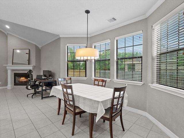 12008 7th St, Santa Fe, TX 77510 - dining room with light tile patterned floors, ornamental molding, baseboards, a lit fireplace, and vaulted ceiling