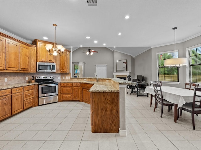 12008 7th St, Santa Fe, TX 77510 - kitchen with stainless steel appliances, crown molding, a sink, a peninsula, and a fireplace
