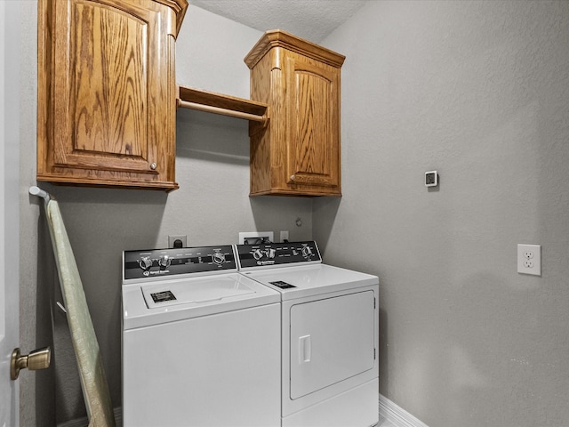12008 7th St, Santa Fe, TX 77510 - laundry area with independent washer and dryer, cabinet space, baseboards, and a textured wall