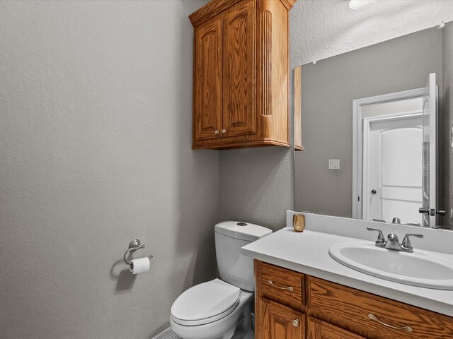 12008 7th St, Santa Fe, TX 77510 - bathroom with vanity, toilet, and a textured wall