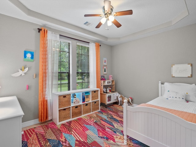 12008 7th St, Santa Fe, TX 77510 - bedroom featuring a raised ceiling, ceiling fan, and baseboards