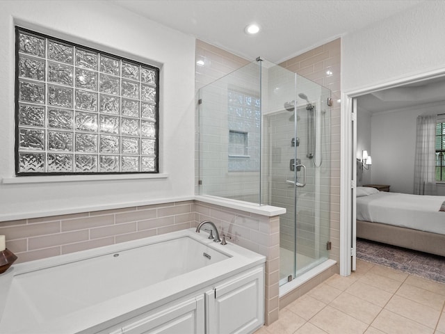 12008 7th St, Santa Fe, TX 77510 - ensuite bathroom featuring a bath, a stall shower, tile patterned flooring, and recessed lighting
