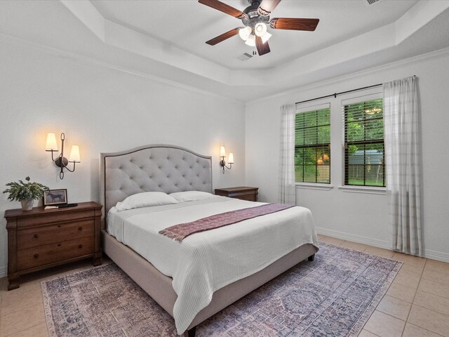 12008 7th St, Santa Fe, TX 77510 - bedroom featuring a tray ceiling, light tile patterned floors, baseboards, and ceiling fan