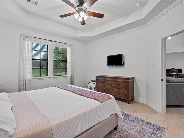 12008 7th St, Santa Fe, TX 77510 - bedroom with a raised ceiling, light tile patterned floors, ceiling fan, crown molding, and baseboards