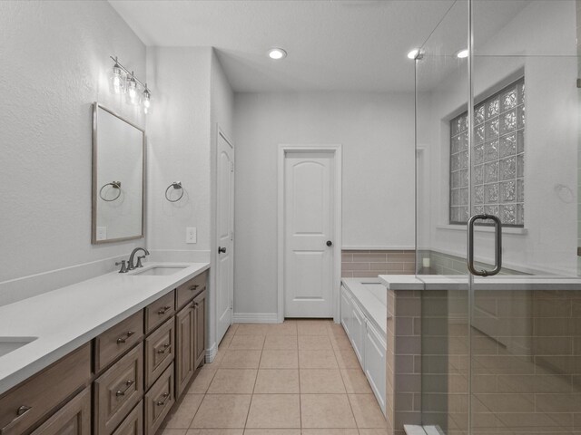 12008 7th St, Santa Fe, TX 77510 - bathroom with double vanity, a bath, tile patterned flooring, a stall shower, and recessed lighting