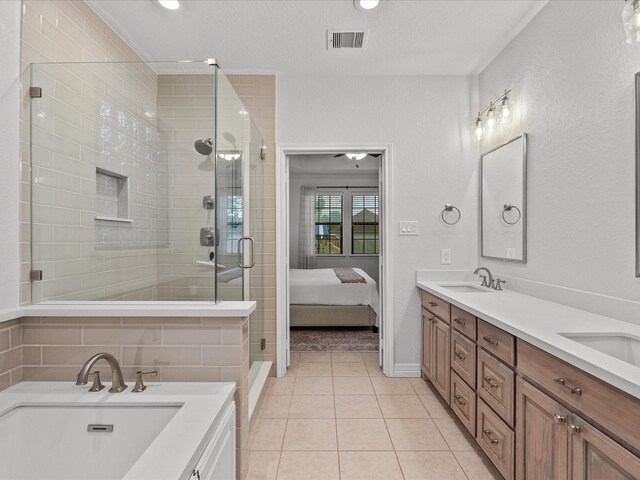 12008 7th St, Santa Fe, TX 77510 - ensuite bathroom with double vanity, a shower stall, tile patterned flooring, recessed lighting, and baseboards