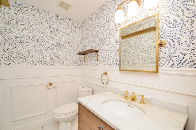 7919 Clarion Way, Houston, TX 77040 - bathroom with wallpapered walls, vanity, wainscoting, toilet, and tile patterned floors