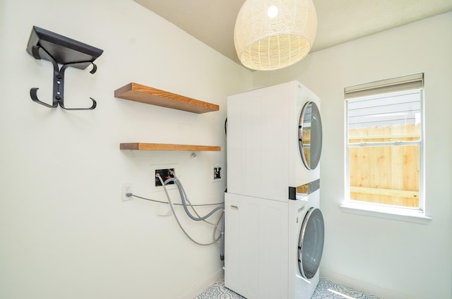 7919 Clarion Way, Houston, TX 77040 - laundry room featuring estacked washer and dryer and baseboards