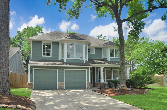 7919 Clarion Way, Houston, TX 77040 - view of front of home with driveway, covered porch, a garage, and stone siding