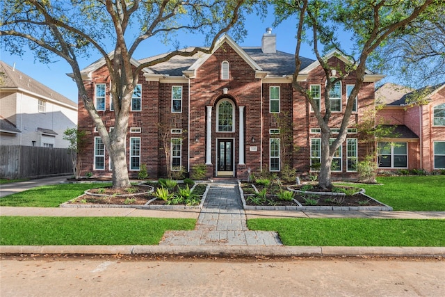 14130 Glasgow Pl, Houston, TX 77077 - traditional-style house featuring brick siding and a chimney