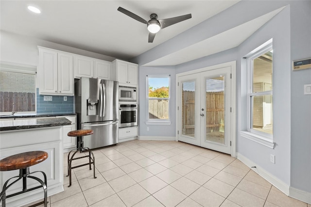 14130 Glasgow Pl, Houston, TX 77077 - kitchen featuring stainless steel appliances, french doors, ceiling fan, baseboards, and white cabinetry