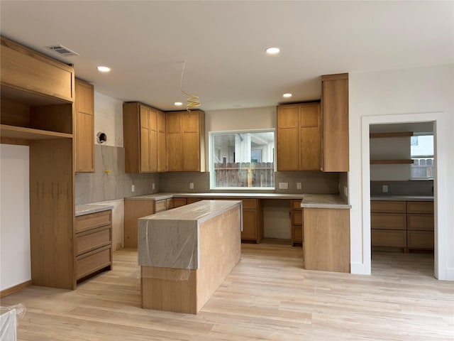 5005 Chestnut St, Bellaire, TX 77401 - kitchen featuring healthy amount of natural light, backsplash, light wood-style floors, and recessed lighting