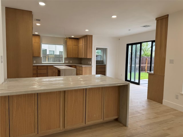 5005 Chestnut St, Bellaire, TX 77401 - kitchen with plenty of natural light, light countertops, recessed lighting, light wood-type flooring, and backsplash