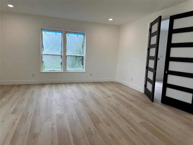 5005 Chestnut St, Bellaire, TX 77401 - spare room featuring light wood-style flooring, baseboards, and recessed lighting