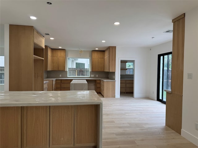 5005 Chestnut St, Bellaire, TX 77401 - kitchen featuring plenty of natural light, light wood finished floors, baseboards, light countertops, and recessed lighting