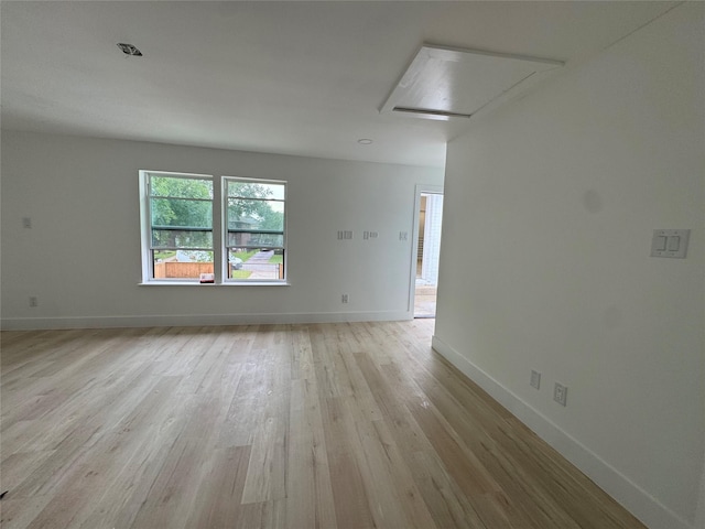 5005 Chestnut St, Bellaire, TX 77401 - spare room with attic access, light wood finished floors, and baseboards