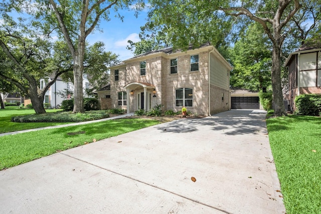 16907 Misty Creek Dr, Spring, TX 77379 - view of front of property with brick siding, a front lawn, and a detached garage