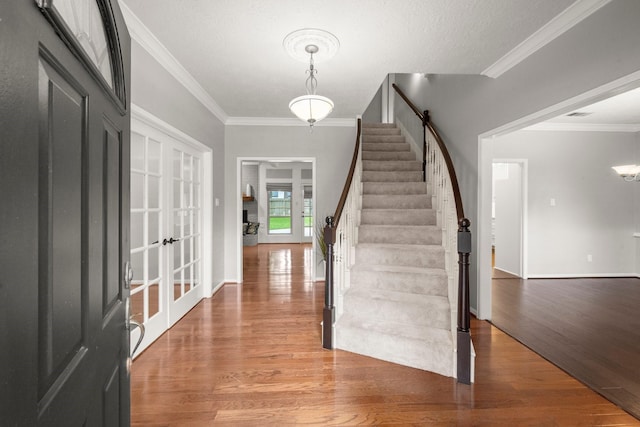 16907 Misty Creek Dr, Spring, TX 77379 - entryway featuring ornamental molding, light wood-style floors, stairway, baseboards, and french doors